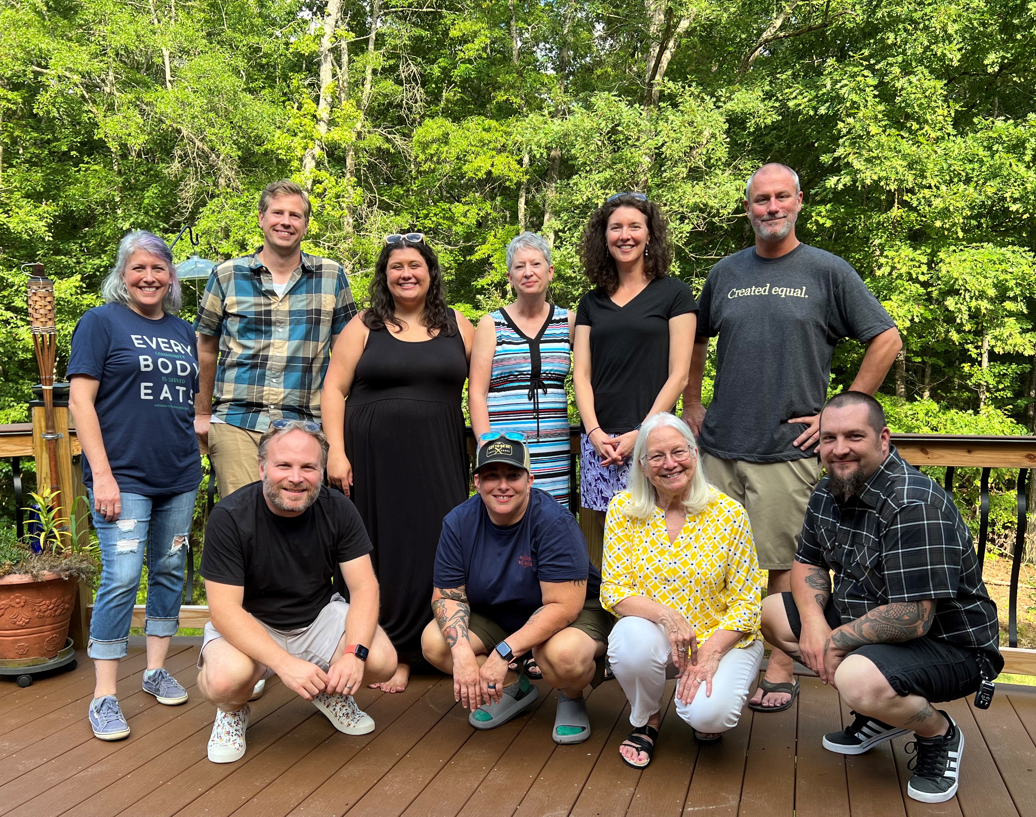 The Quiltmaker Cafe Founders & Directors, July 2022.  Front, left to right:  Brent Levy, Sera Cuni, Susan Hughes, and Bill Hartley. Back, left to right: Jennie Knowlton, Cody Marshall, Elizabeth Knowlton, Laraine Nicklaw, Jennifer Hedrick and David Knowlton